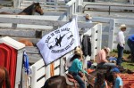 cowgirls on horseback presenting the rodeo flag