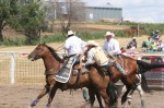 Pickup men Joe Blankenship an Brad Marshall safely picking up a cowboy off of a bucking horse
