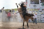 Rusty Wright on a bucking horse that is practically vertical